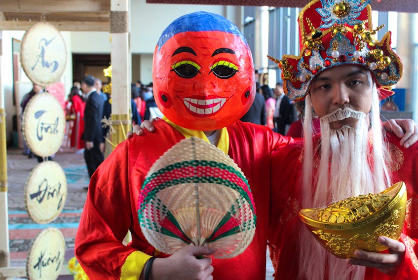 Robert Vo, right, and Huy Vuong, masked, got dressed up to celebrate the Lunar New Year with hundreds of P.E.I.'s Vietnamese community at the Delta Hotel in Charlottetown on Feb. 1. Vo is dressed as the god Than Tai while Vuong is dressed as the spirit Ong Dia. Daniel Brown/The Guardian.