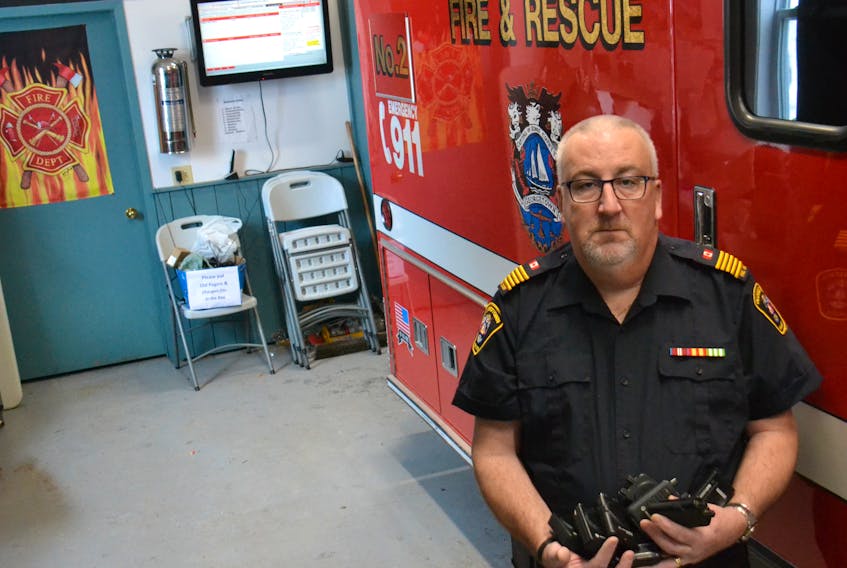 Georgetown Fire Chief Mark Gotell holds a pile of pagers that have been rendered useless after Bell Aliant took the service off-line last July. Gotell estimates his department purchased each of the pagers over the years for $550 apiece.
Stu Neatby/THE GUARDIAN