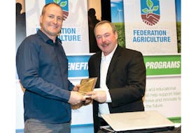 Rit VanNieuwenhuyzen of Vanco Farms Ltd. accepts the Agriculture Awareness Award from Gordon Sobey. Vanco Farms was recognized for its outstanding efforts in projecting a positive image of agriculture on Prince Edward Island. - Photo special to The Guardian by Dan McKinnon