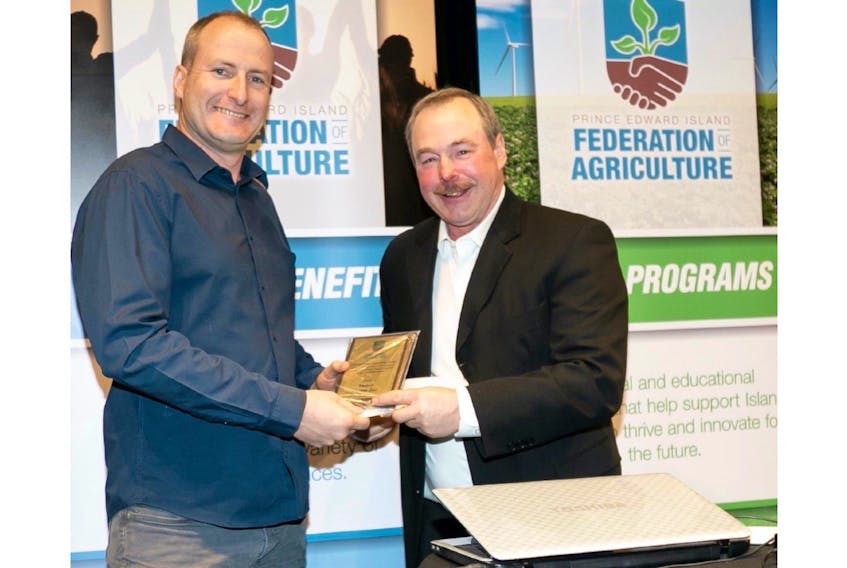 Rit VanNieuwenhuyzen of Vanco Farms Ltd. accepts the Agriculture Awareness Award from Gordon Sobey. Vanco Farms was recognized for its outstanding efforts in projecting a positive image of agriculture on Prince Edward Island. - Photo special to The Guardian by Dan McKinnon