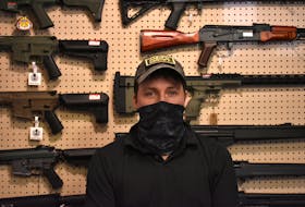 Andy Hardy, owner of Andy's Airsoft in Charlottetown, stands in front of a display of some of the airsoft guns he sells. If Bill C-21 were to become law, they would all be illegal for Hardy to sell, effectively ending his business.