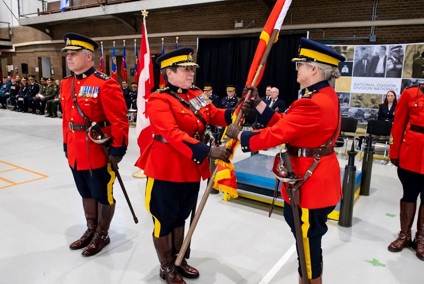 Bernadine Chapman, right, receives the RCMP's National Division Insigne flag from RCMP Commissioner Brenda Lucki during the swearing in ceremony Nov. 27 promoting Chapman to commanding officer of the National Division.