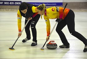 Lead Michelle McQuaid, left, and second Meaghan Hughes of the Suzanne Birt rink sweep a rock during the Scotties P.E.I. women’s curling championship at the Maple Leaf Curling Club in O’Leary on Saturday afternoon. The Birt rink defeated Darlene London 3-0 in the best-of-five series to earn the right to represent P.E.I. at the Scotties Canadian women’s curling championship in Calgary from Feb. 20 to 28.