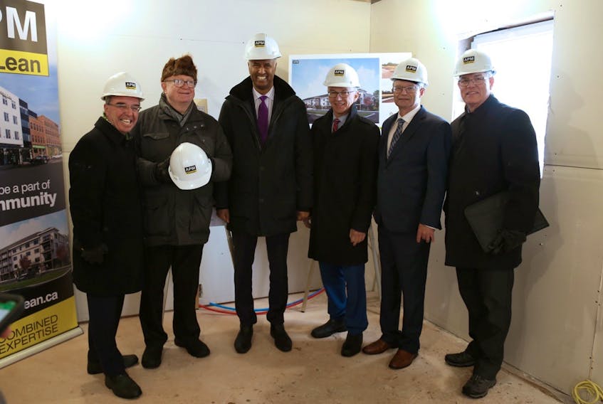 Charlottetown Mayor Philip Brown, left, joins Bill Campbell, federal Social Development Minister Ahmed Hussen, Charlottetown MP Sean Casey, provincial Housing Minister Ernie Hudson and Terry Palmer, vice-president of finance, Pan American Properties Inc. at Stratford Place on March 3.