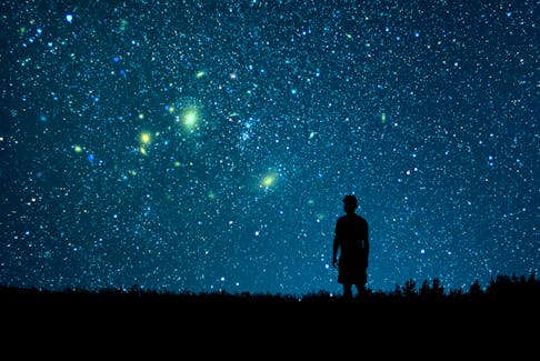 A man looks looks at the starry sky.
