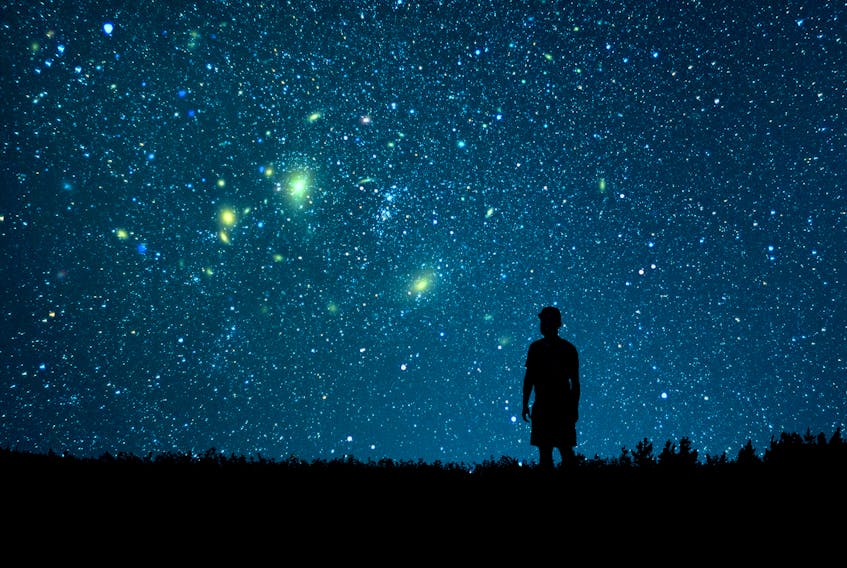 A man looks looks at the starry sky.