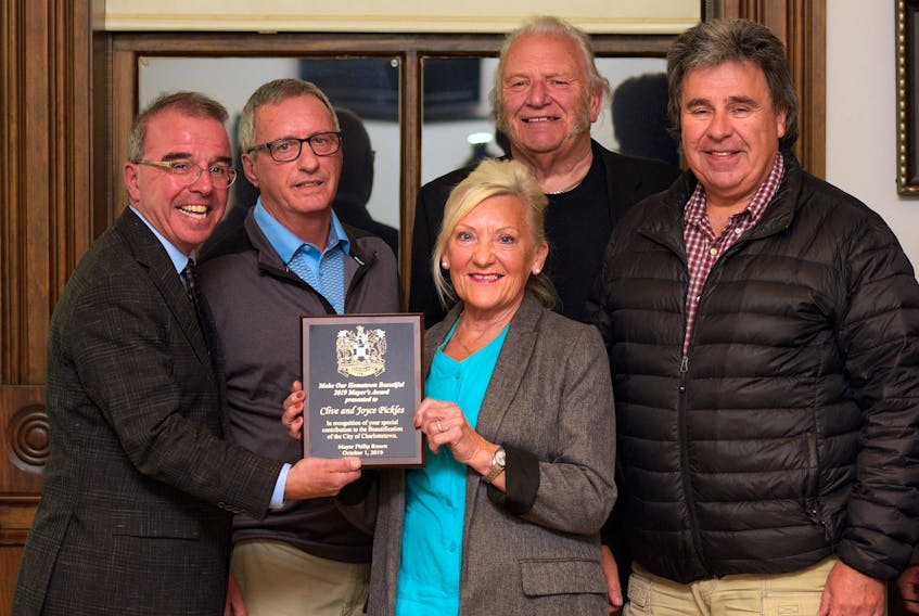 Mayor Philip Brown, left, Coun. Kevin Ramsey and Coun. Mitchell Tweel present Clive and Joyce Pickles with the 2019 Mayor’s Award for their property on Euston Street.