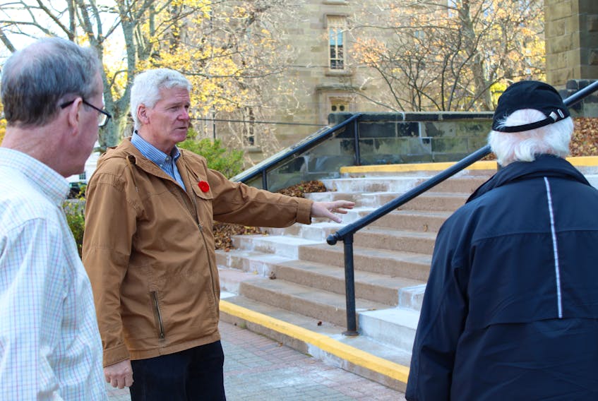 Don Lott, middle, showcases the front steps of St. Dunstan's Basilica during the Armchair Tour at the Confederation Centre Public Library in Charlottetown on Nov. 2. While most of the tour consisted of a presentation, Lott invited attendants to walk around to see some discussed buildings afterward.