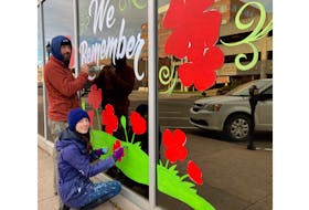 Commercial artists Starla Wilson and Ryan Wilson of Shiny Paint bring the message of Remembrance Day to P.E.I.’s capital as they decorate a business window this past Sunday afternoon. They were hired by Business Technology Consulting on Queen Street.