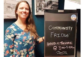 Krystal Dionne, a branch technician with the Montague Rotary Library, located in the Cavendish Farms Wellness Centre, poses with the new community fridge. People can come take a variety of food from the fridge at no cost on Wednesdays and Thursdays between 3 and 5 p.m.
