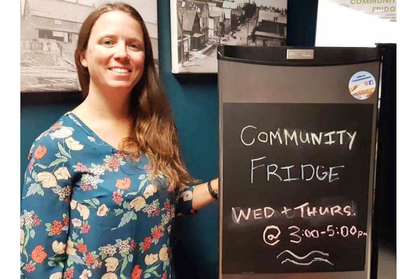 Krystal Dionne, a branch technician with the Montague Rotary Library, located in the Cavendish Farms Wellness Centre, poses with the new community fridge. People can come take a variety of food from the fridge at no cost on Wednesdays and Thursdays between 3 and 5 p.m.