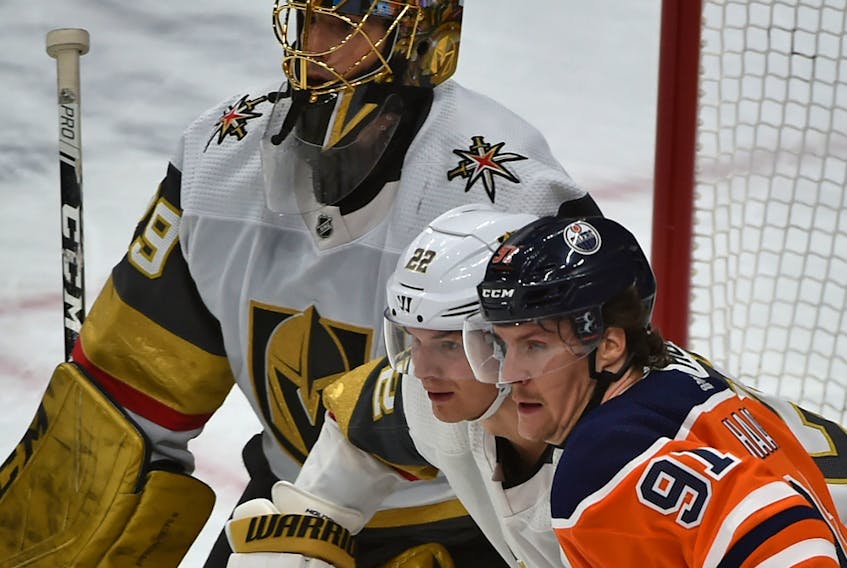 Edmonton Oilers forward Gaetan Haas, right, and Vegas Golden Knights defenceman Nick Holden battle in front of goalie Marc-Andre Fleury on March 9. - Postmedia