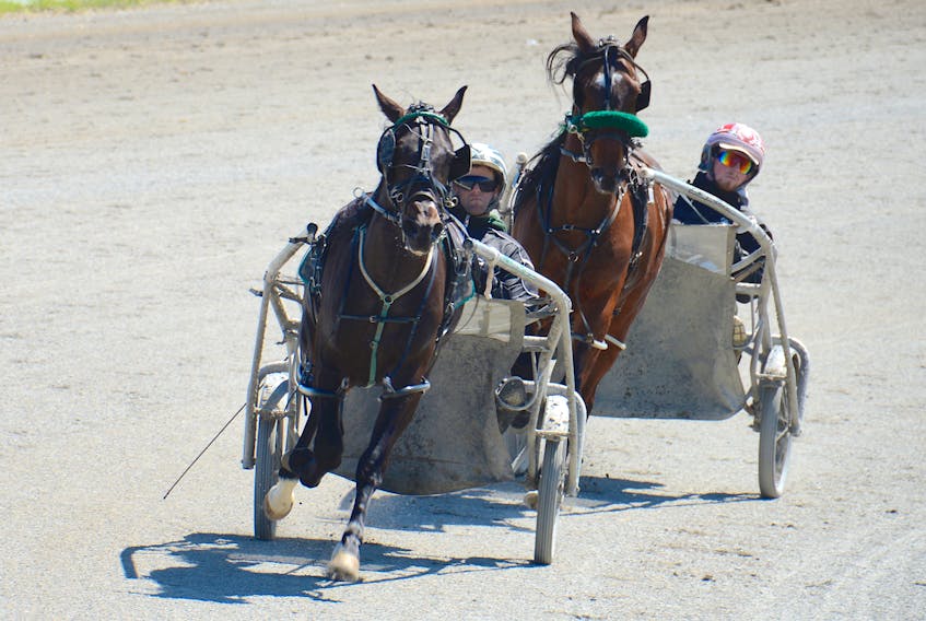 Marc Campbell, left, with Yakushev and Kyle Gillis with Cade were training Wednesday morning at Red Shores at the Charlottetown Driving Park. The first races of the season go tonight.
