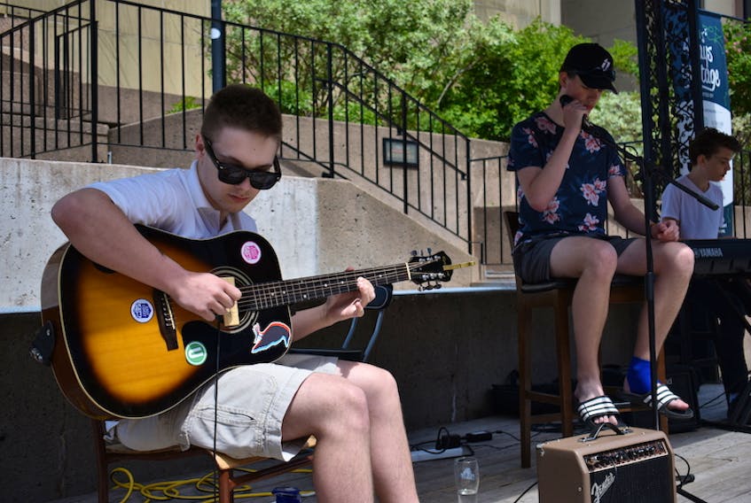 Elijah Moase, left, Sam Read and Malcolm Orford, three members of the band the Darvel, give a socially distanced performance at Always on Stage earlier this month in Charlottetown. Due to restrictions and the size of the stage, the other three members could not perform.