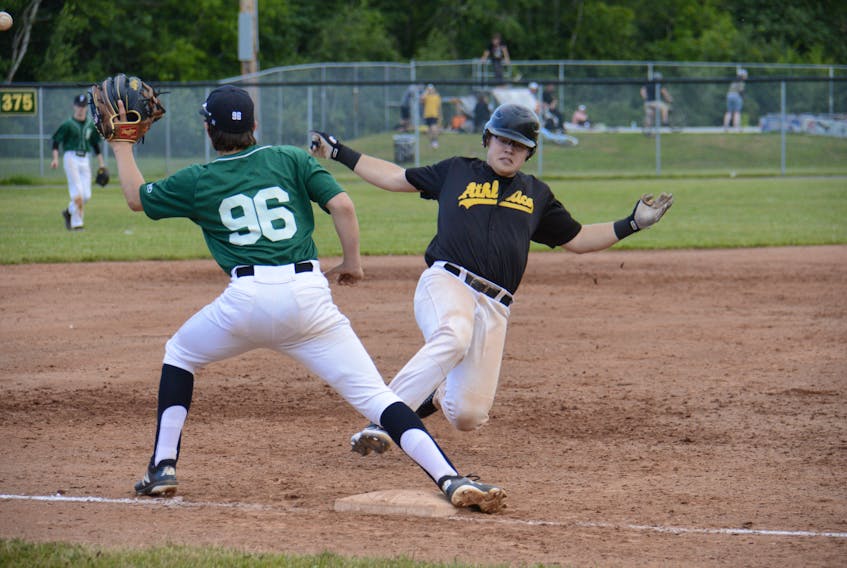 Grant Grady of The Alley Stratford Athletics slides safely into third ahead of the tag of P.E.I. Youth Selects’ third baseman Sam Worth during Kings County Baseball League action Friday at Memorial Field.