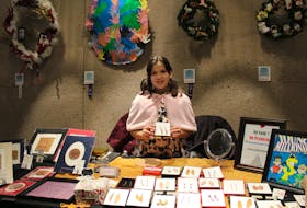 Makayla Bernard, 11, holds up earrings she crafted from birch bark at the Mi’kmaq and Indigenous Artisan Market held earlier this month at the Confederation Centre of the Arts in Charlottetown.