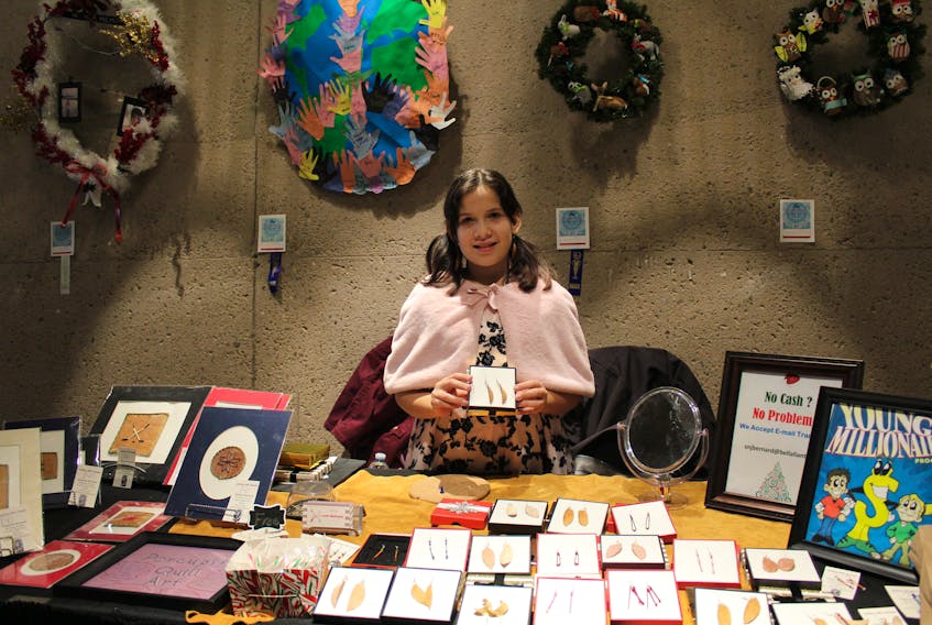 Makayla Bernard, 11, holds up earrings she crafted from birch bark at the Mi’kmaq and Indigenous Artisan Market held earlier this month at the Confederation Centre of the Arts in Charlottetown.