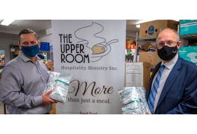 Three-ply, non-medical and reusable masks are now available at all food bank locations across the province. Mike MacDonald, left, executive director of the P.E.I. Association of Food Banks, and Social Development and Housing Minister Ernie Hudson display some of the masks.