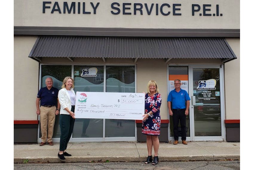 Andrea MacDonald, left, with United Way and Kathy Jones with Family Services P.E.I. accept a recent donation from P.E.I. Mutual Insurance Company’s CEO Blair Campbell, back left, and board chairman Brian Annear. P.E.I. Mutual has donated $52,000 to local food banks and to Family Services P.E.I. to help Islanders make it through the pandemic.
