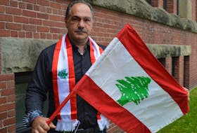 Paul Haddad, one of the many Lebanese residents living in Charlottetown, displays the Lebanese flag in a sign of solidarity following the devastating explosion that rocked Beirut on Tuesday.