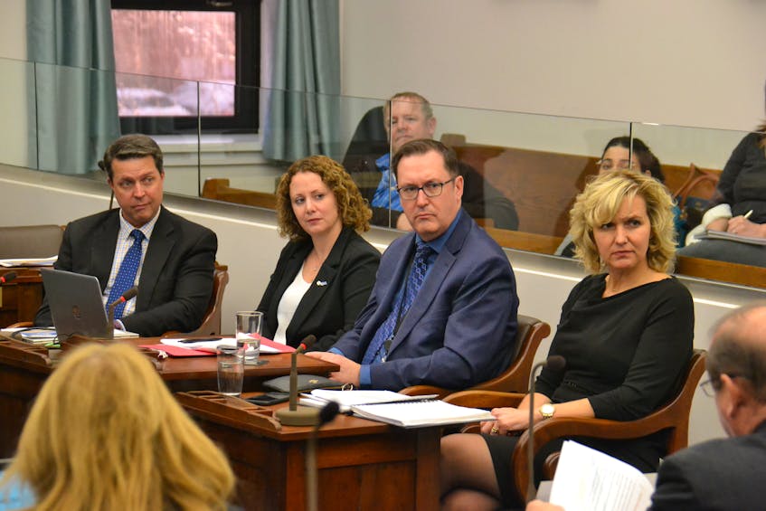 Education Minister Brad Trivers, left, makes a presentation to the standing committee on education and economic crowth on Tuesday. Also presenting were Becky Chaisson of the Public Schools Branch, as well as John Cummings and Bethany MacLeod of the Department of Education.