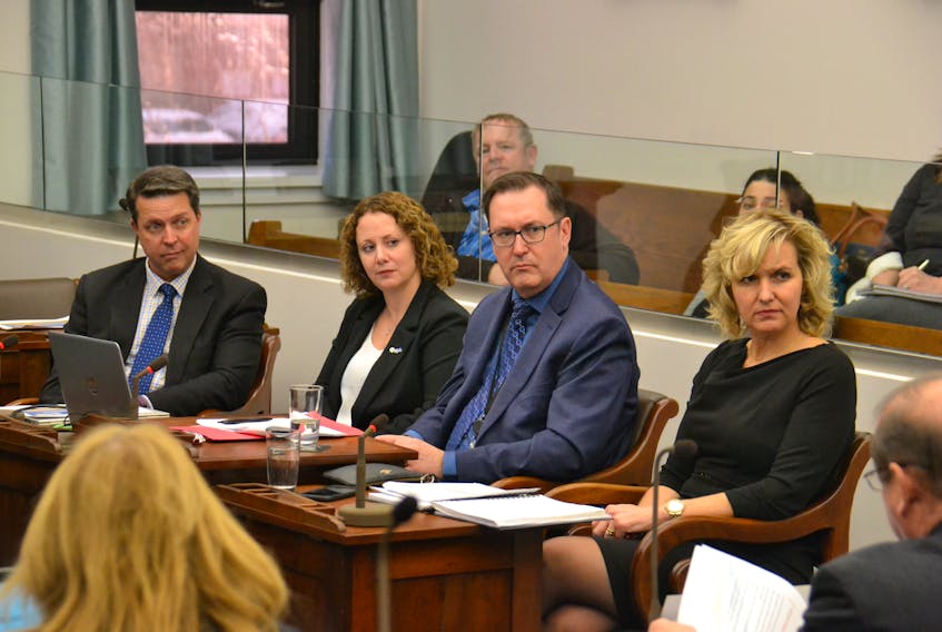 Education Minister Brad Trivers, left, makes a presentation to the standing committee on education and economic crowth on Tuesday. Also presenting were Becky Chaisson of the Public Schools Branch, as well as John Cummings and Bethany MacLeod of the Department of Education.