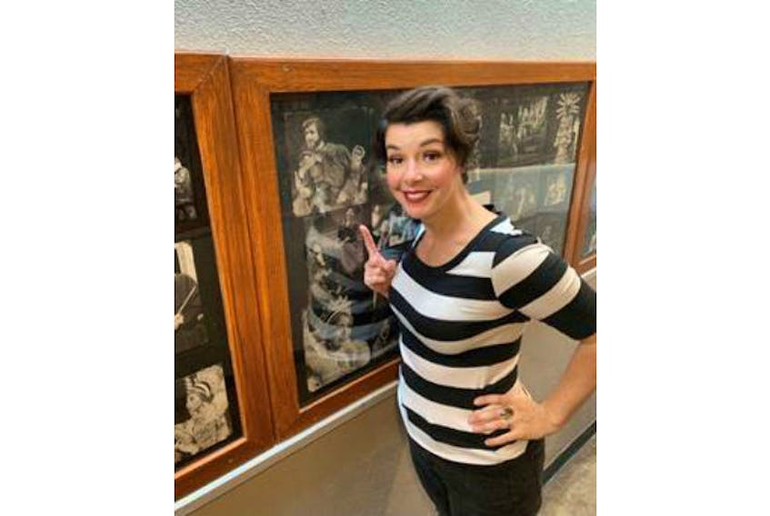 Sara-Jeanne Hosie points to a photo of her father Bill in the backstage wall of fame of past productions at the Charlottetown Festival.