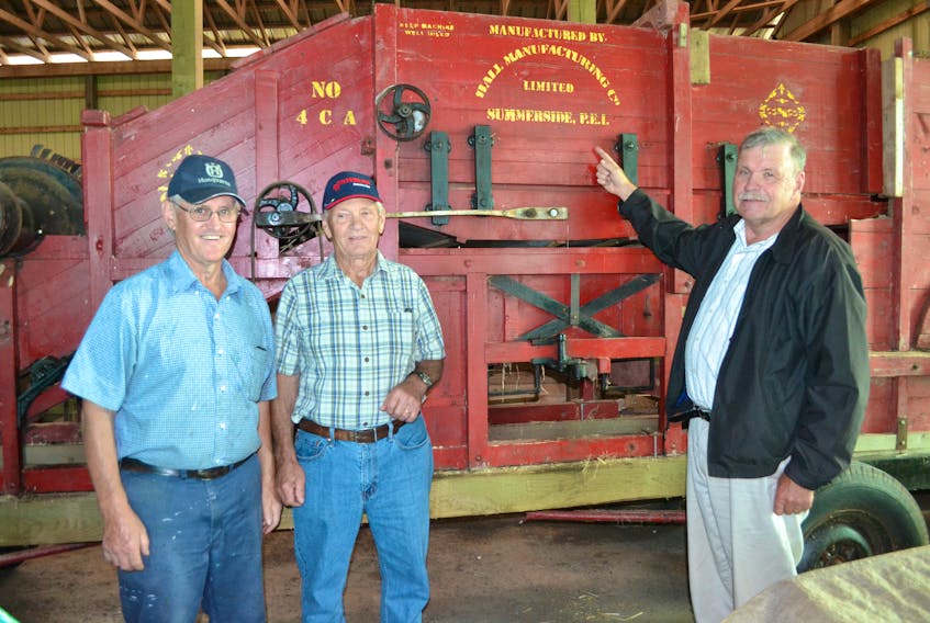 Organizers of Hamilton Heritage Day display an antique threshing machine, which was built by the Hall Manufacturing Company in Summerside. It's one of the pieces that will be on display at the Saturday, Sept. 14 event. From left are Jimmy Carruthers, Myron Taylor and Michael Delaney.