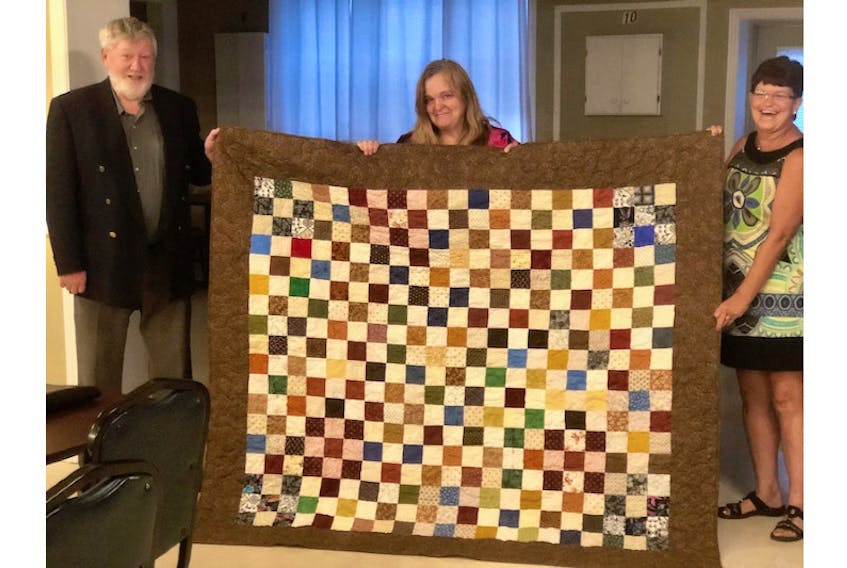 Marlene (Marle) Windsor Gaudet, centre, was recently presented with a Quilt of Valour at the Royal Canadian Legion in Summerside. George Dalton, representing the provincial command of the Royal Canadian Legion, and Barb Gallant, chair of the Royal Canadian Legion Lest We Forget committee, made the presentation.
