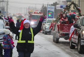 Wanda Banks helps regulate traffic and spread some Christmas cheer during the 39th Annual Christmas Parade in Souris on Dec. 7. Daniel Brown/The Guardian