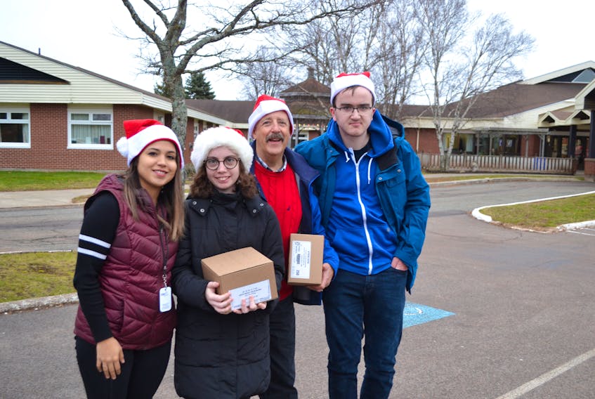 Representatives from Stars for Life are in the holiday spirit as they prepare to deliver Christmas cards to residents at Beach Grove Home in Charlottetown last week. From left are Allie Rodriguez, Patti Bradley, Ron Casey and Liam Paquet. Clients and staff will deliver over 1,000 cards to manors and homes by the time they’re finished.