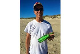 Roy Huntley shows off the message in a bottle he and his wife, Ann, discovered on Ocracoke Island, N.C. on Nov. 10.