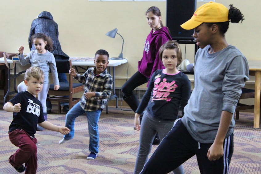 Reequal Smith, right, teaches youth a coordinated dance during a Black History Month event at the Confederation Centre Public Library in Charlottetown on Feb 8.