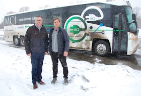Mike Cassidy, right, owner of Maritime Coach Atlantic, gave P.E.I. Transportation Minister Steven Myers and others a demonstration run Monday aboard this 100 per cent battery electric motorcoach currently going for test drives in the Maritimes.