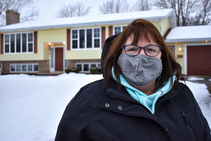 Anne Quinn stands in front of the house on Enman Crescent in Charlottetown she thought she was going to be renting, until she found out she was the victim of a rental scam.