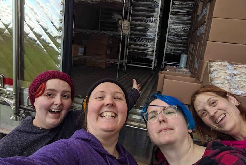 From left, Miranda Lowther, Lois Craswell, Katelyn Craswell and Stephanie Leavitt taking a happy and relieved selfie in front the reefer truck provided by Atlantic Beef Products. It helped them save much of their stock after the power outage caused by Dorian. Photo by Lois Craswell