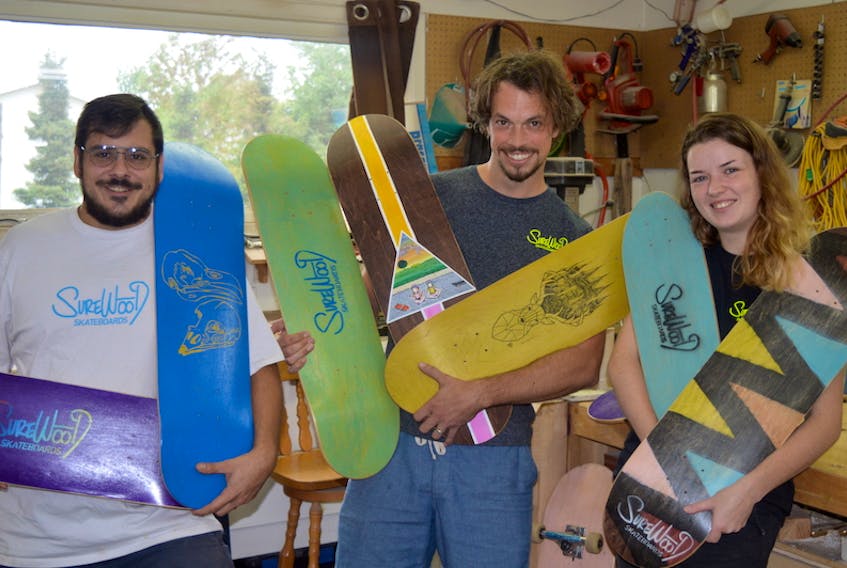 Three Charlottetown entrepreneurs have launched P.E.I.’s first skateboard manufacturing business. From left are Jeffrey Lockert, Jamie Crawford and Emily Cornish.