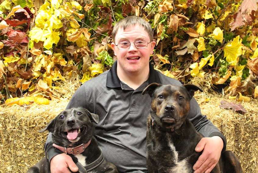 Travis Bakker poses with his two pups, Katie and Ellie-Mae, during the Paws & Pose at Victoria Park in Charlottetown on Nov. 9. The fundraiser welcomed one and all to have professional photos taken of them and their pets, with all proceeds going toward Hearts of the North.