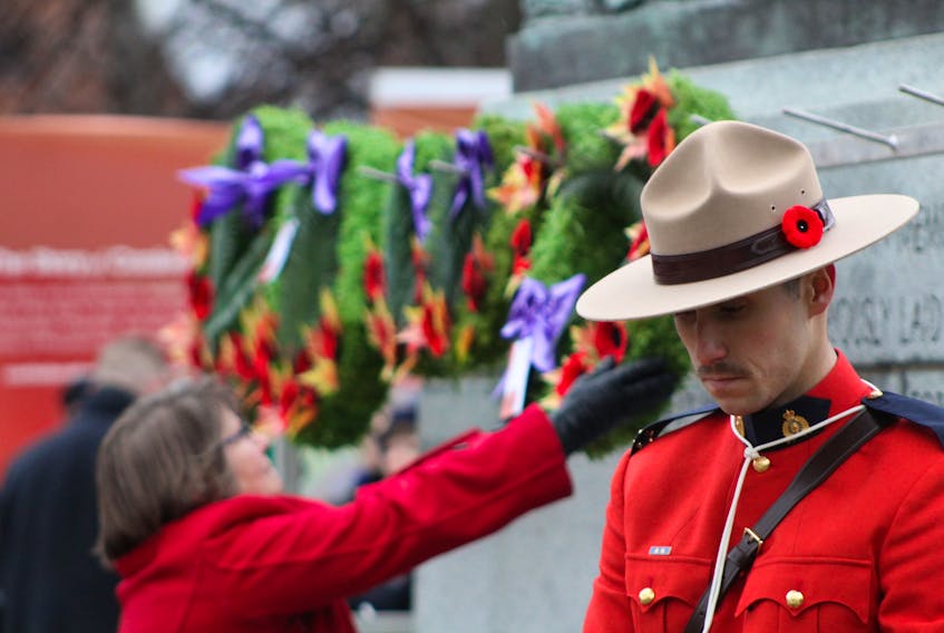 Charlottetown residents lay wreaths on the Charlottetown Cenotaph as a RCMP stands near on Tuesday, Nov. 11. Daniel Brown/The Guardian