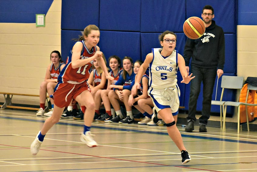 Dru Gillis of the Summerside Intermediate Owls races with the basketball while Leah Campbell of the East Wiltshire Warriors hustles back. The action took place during the Summerside Intermediate School’s 43rd annual Glenn Edison Memorial tip-off basketball tournament last weekend.