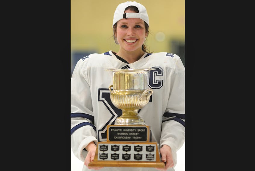 St. Francis Xavier X-Women centre Lydia Schurman holds the Atlantic University Sport women’s hockey championship trophy. The X-Women will represent the conference at the U Sports national women’s hockey championship in Charlottetown this week. - Bryan Kennedy