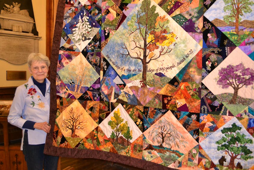 Curator Carol MacDonald stands next to Tree of Life, a quilt by Brenda Creighton. It took Creighton 14 years to hand quilt the piece. It’s one of the pieces in Stories in Stiches IV — a show underway at St. Paul’s Church in Charlottetown.