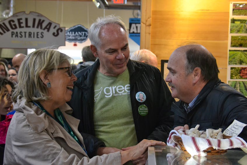 Federal Green party leader Elizabeth May and P.E.I. Green party leader Peter Bevan-Baker chat with a vendor at the Charlottetwon Farmers Market on Saturday. The federal Greens are hoping to capitalize on the recent success of their provincial counterparts, and hope to send one or more of their Island candidates to Ottawa.
Stu Neatby/THE GUARDIAN