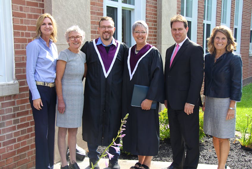 Holland College official Natalie Mitton, left, RN Carole Dixon, Justin MacConnell, Marlaine Gillis, Health Minister James Aylward and Anne Partridge of the Holland College board of governors celebrate resident care worker program graduates in Montague recently.