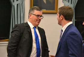 Transportation, Infrastructure and Energy Minister Steven Myers speaks to MLA Corey Deagle in the Coles Building on Tuesday.
