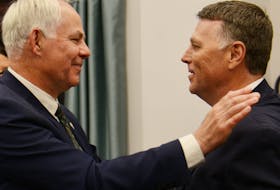 Opposition Leader Peter Bevan-Baker and Premier Dennis King share a hug during the spring sitting of the P.E.I. legislature.