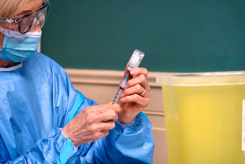 A nurse draws a dose of the Moderna vaccine from a vial at the Wedgewood Manor in Summerside on January 8.