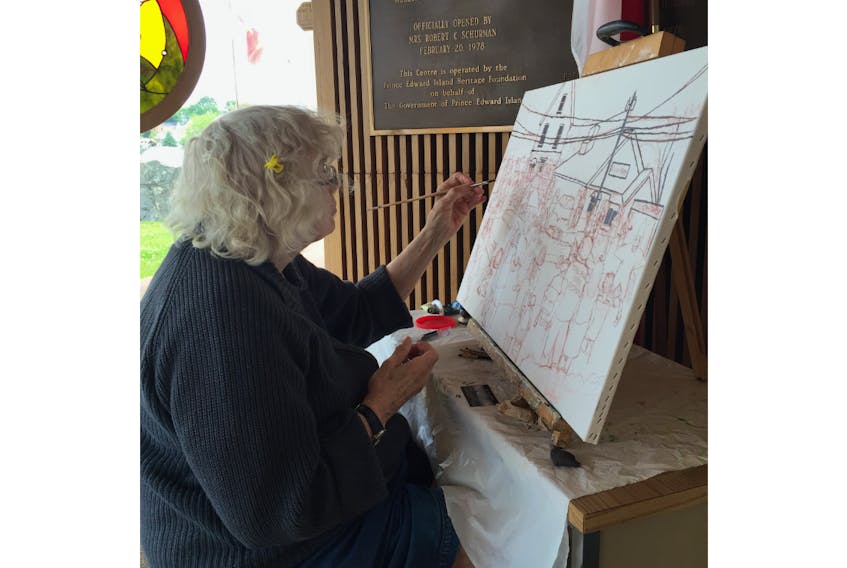 Nan Ferrier is shown at work on a recent piece of art. Her work will be featured in an exhibit that opens Sunday at Eptek Centre in Summerside.