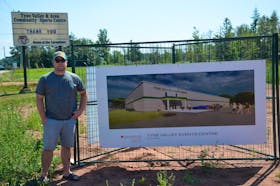 Adam MacLennan stands by a drawing of the new Tyne Valley and Area Events Centre. The new facility will be built on the grounds where the Tyne Valley and Area Community Sports Centre stood from 1964 until 2019.