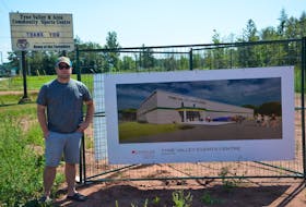 Adam MacLennan stands by a drawing of the new Tyne Valley and Area Events Centre. The new facility will be built on the grounds where the Tyne Valley and Area Community Sports Centre stood from 1964 until 2019.